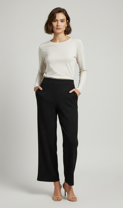 Model wearing black ribbed flare pants by A 'n' A
